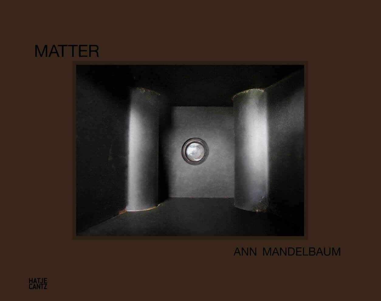 Cover image for 'Matter'. Dark brown background with abstract, metalic shape in the centre. Title printed in black sans serif font, top left