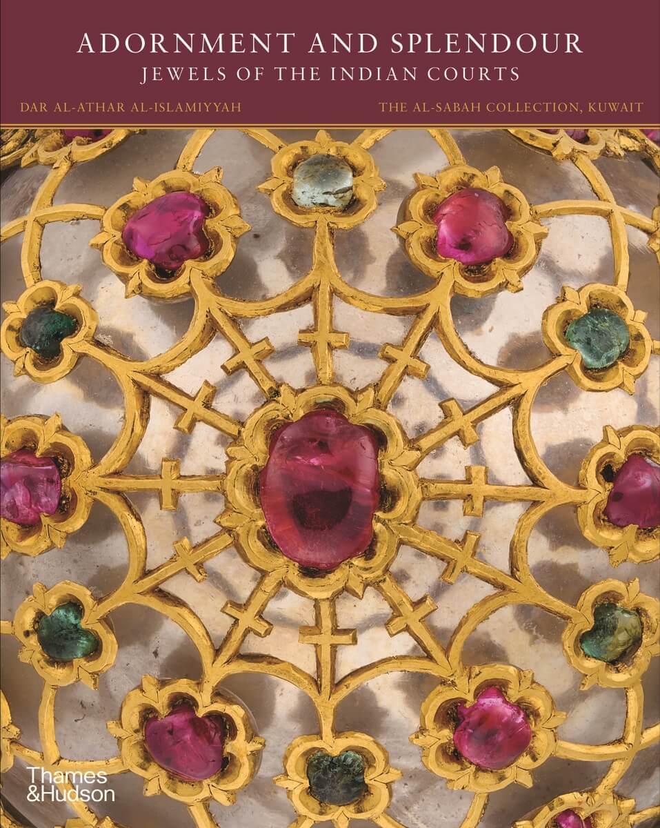 Cover image of photograph of ornate jewels in gold, red and green. Title printed on maroon background strip across top of image in cream font
