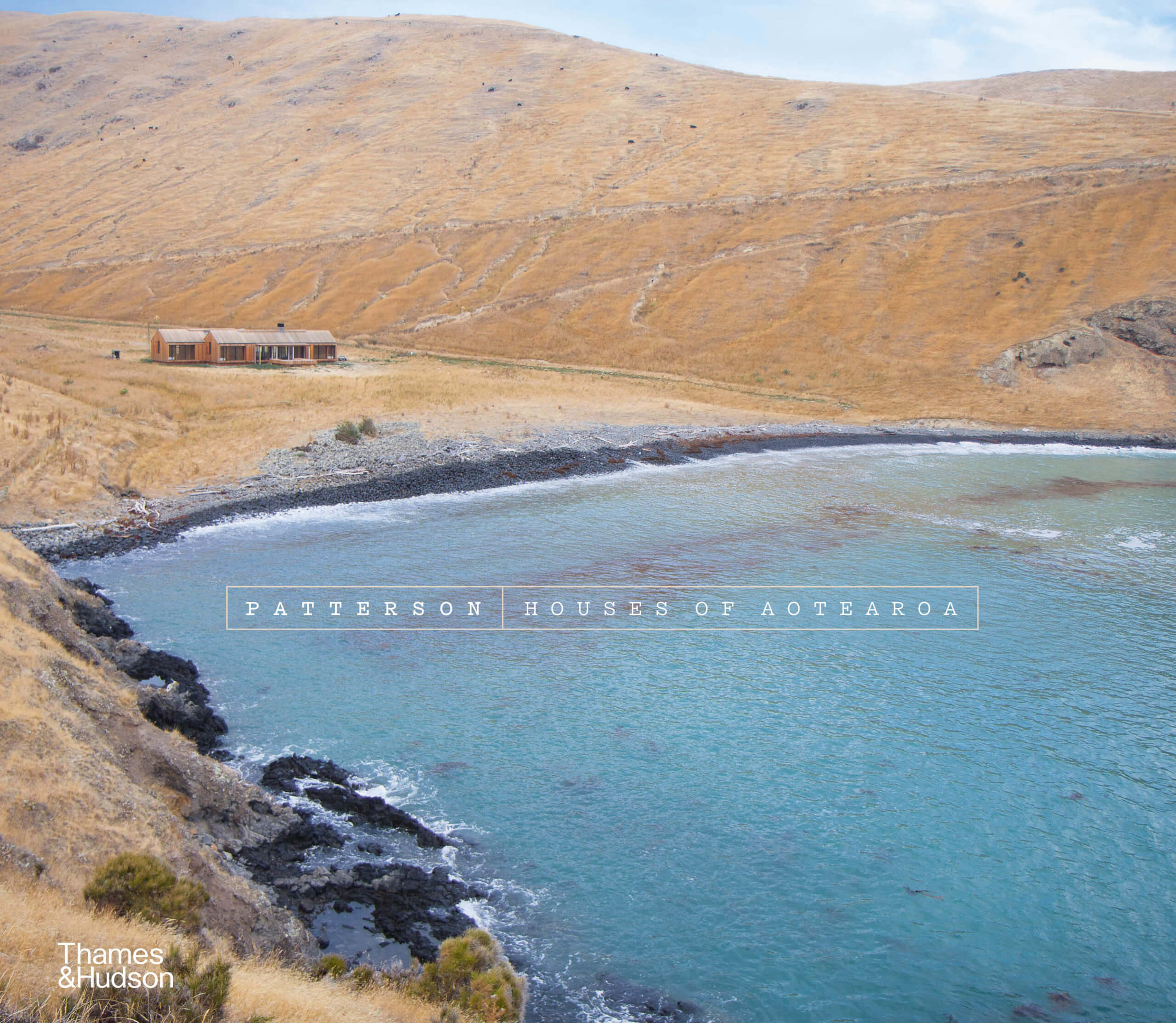 Book cover featuring photograph of small structure nestled in expansive NZ bay. Title in small sans serif white font in middle